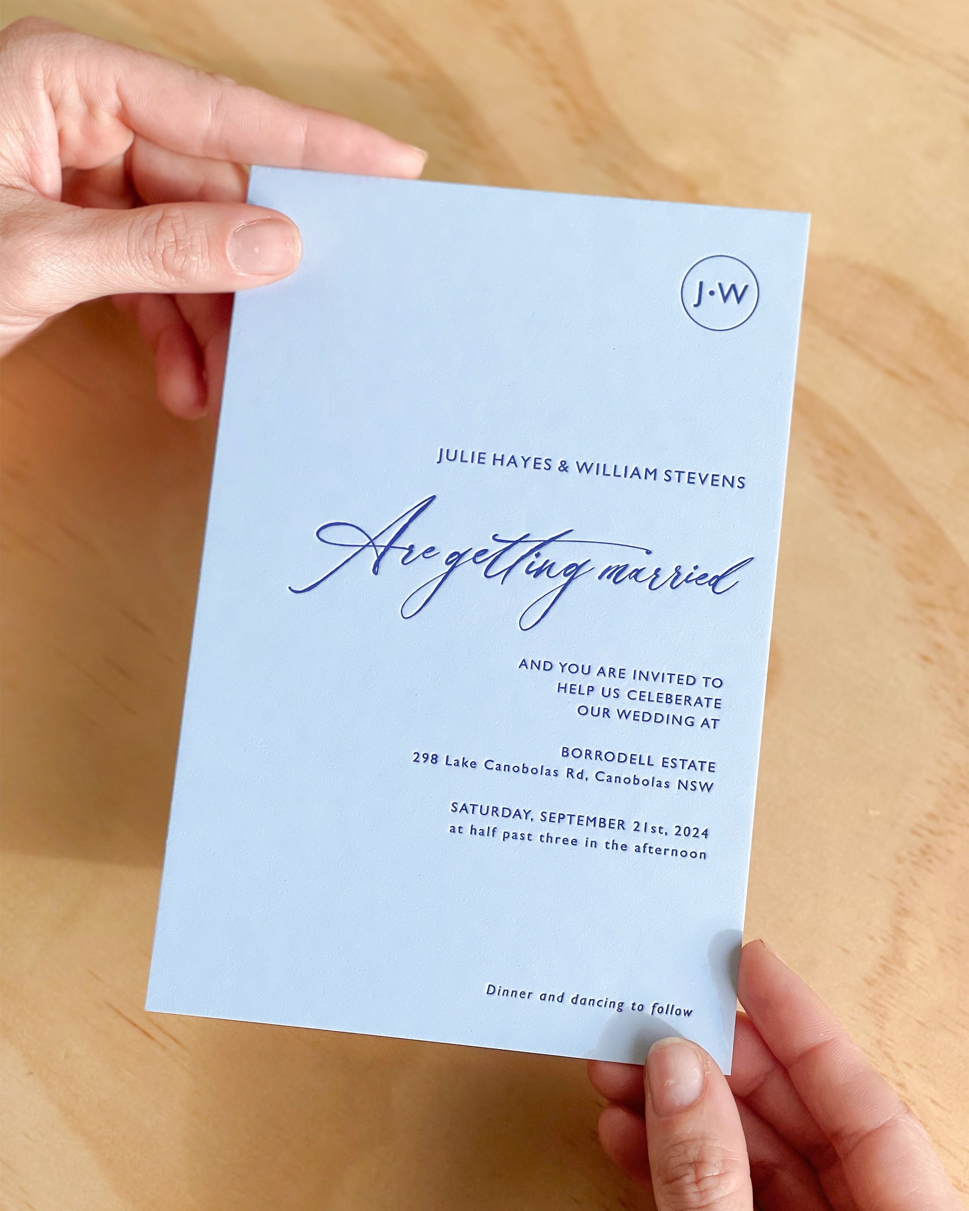 The Newport wedding invitation shown emphasising the letterpress effect of dark blue print on light blue background. A design by Communique Design.