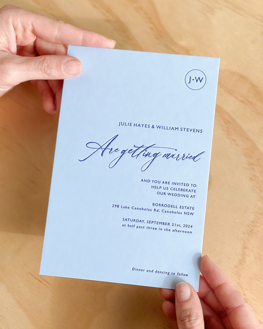 The Newport wedding invitation shown emphasising the letterpress effect of dark blue print on light blue background. A design by Communique Design.