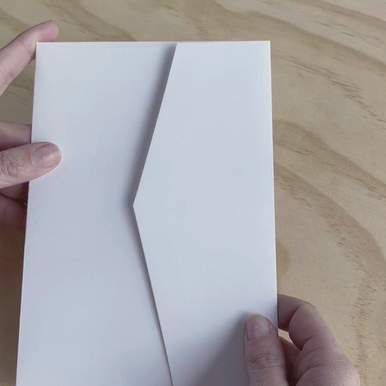 This video shows the Travis wedding invitation with decorative elements including embossed motif. Designed by Communique Design.