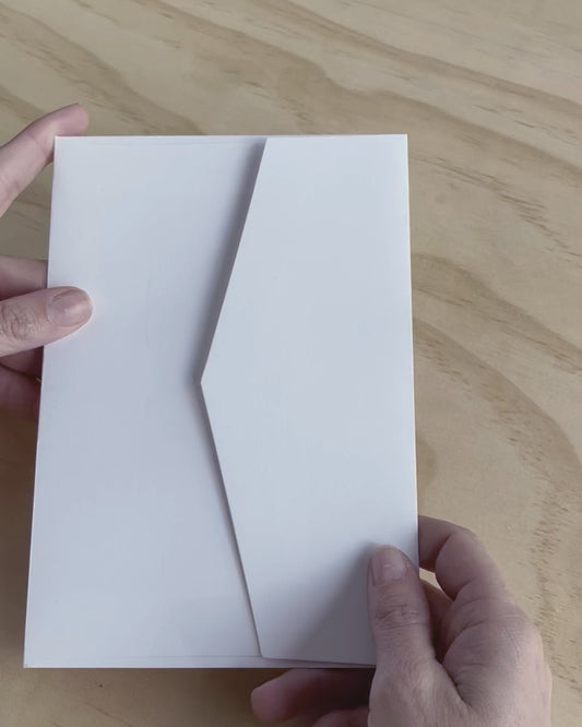 This video shows the Travis wedding invitation with decorative elements including embossed motif. Designed by Communique Design.