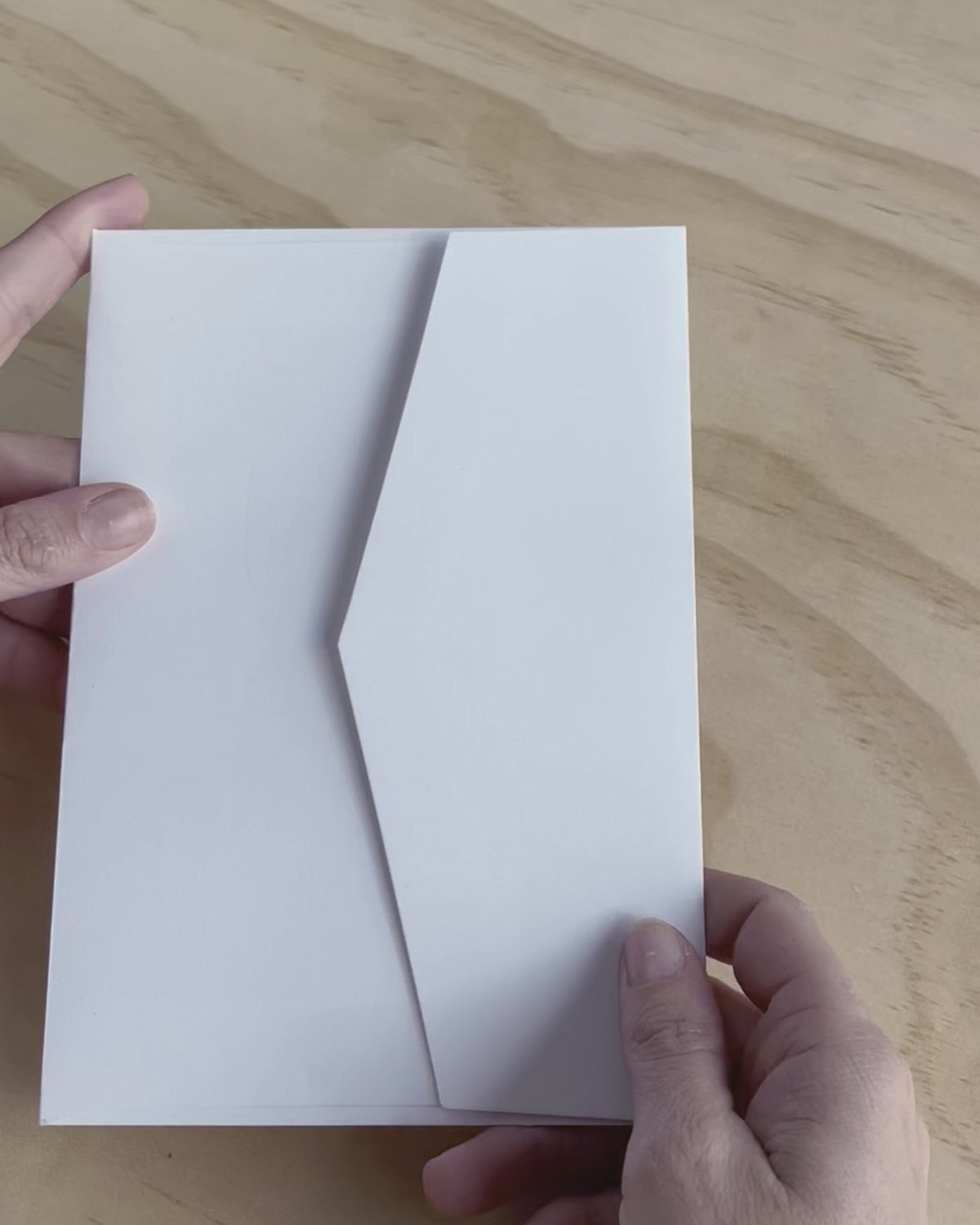 This video shows the Travis wedding invitation with decorative elements including embossed motif. Designed by Communique Design.