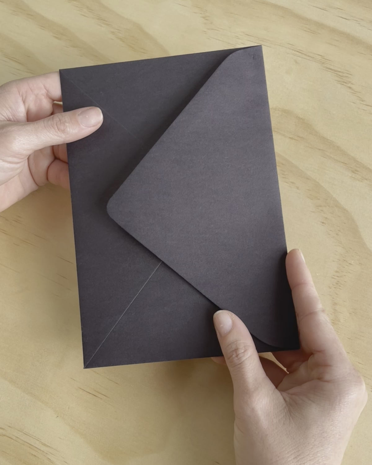 The Avalon wedding invitation video show its rich black heavy card stock, couples names in gold foil and other details in white digital ink. Designed by Communique Design.