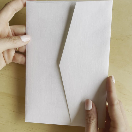 Revealing the Elizabeth wedding invitation, this movie shows the gold foil and white envelope. A design by Communique Design.