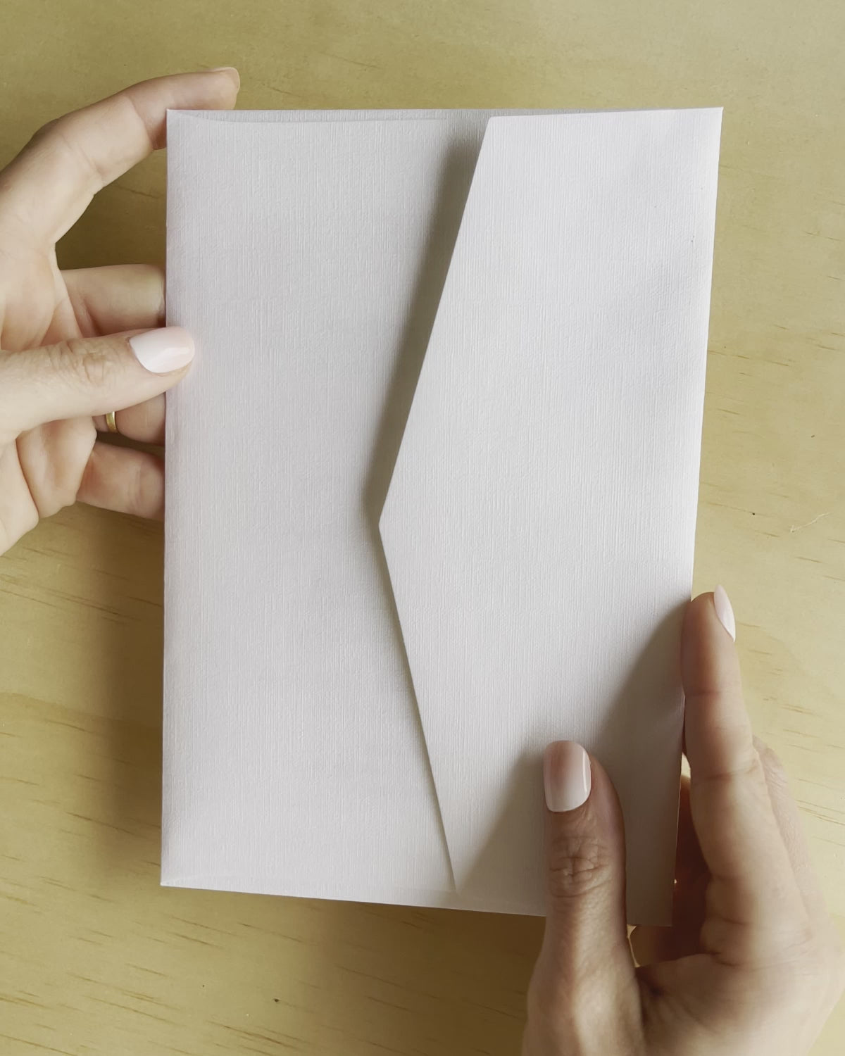 Revealing the Elizabeth wedding invitation, this movie shows the gold foil and white envelope. A design by Communique Design.
