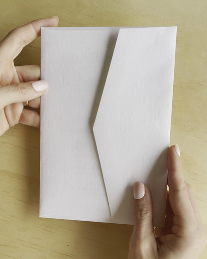 Revealing the Elizabeth wedding invitation, this movie shows the gold foil and white envelope. A design by Communique Design.