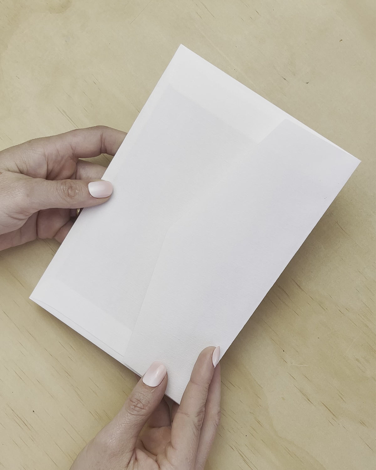 A movie reveal of the Aurora Rose wedding invitation with white envelope. A design by Communique Design.